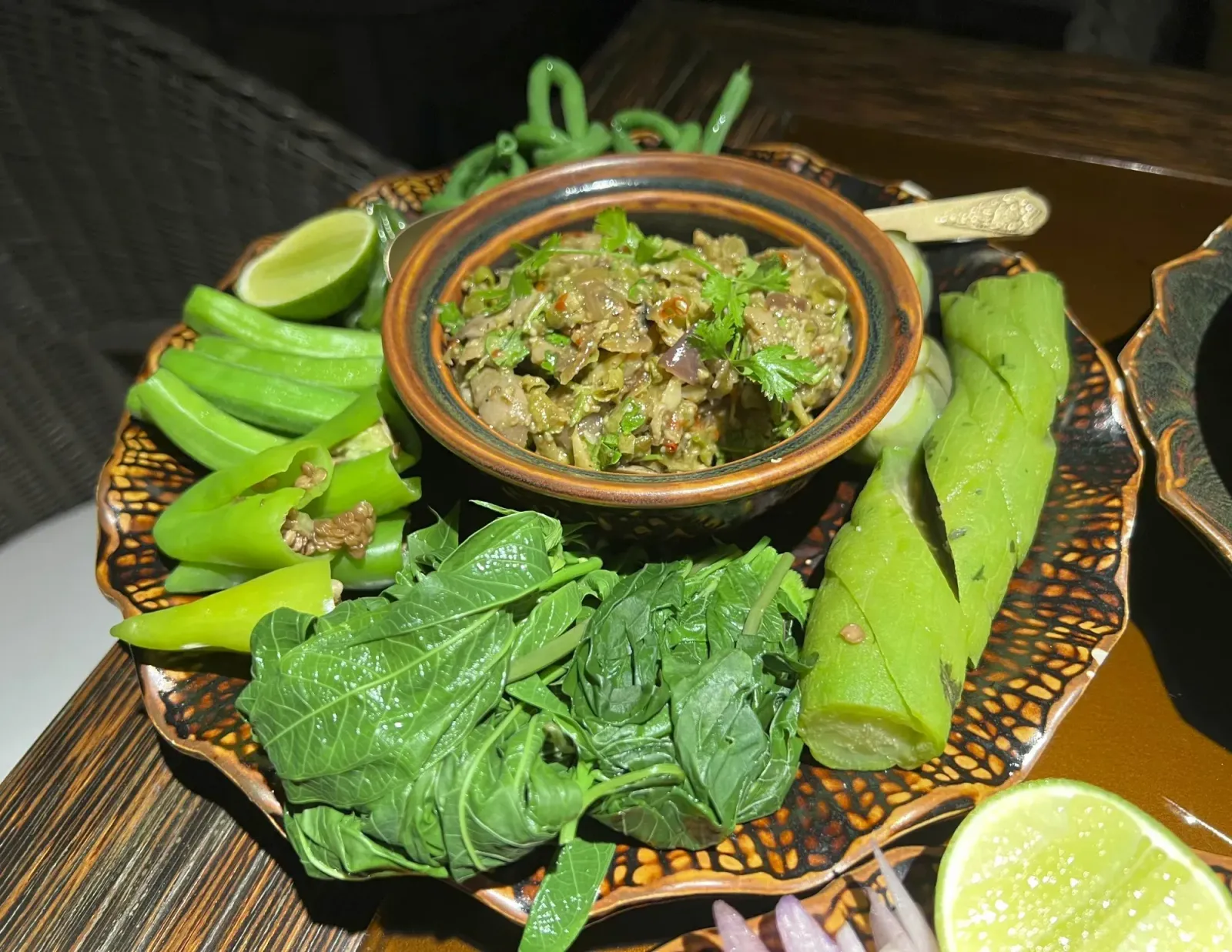 Bok Trop Pgnon by Mr. Wanderer Small dish of Bok Trop Pgnon served surrounded by exclusively green vegetables.