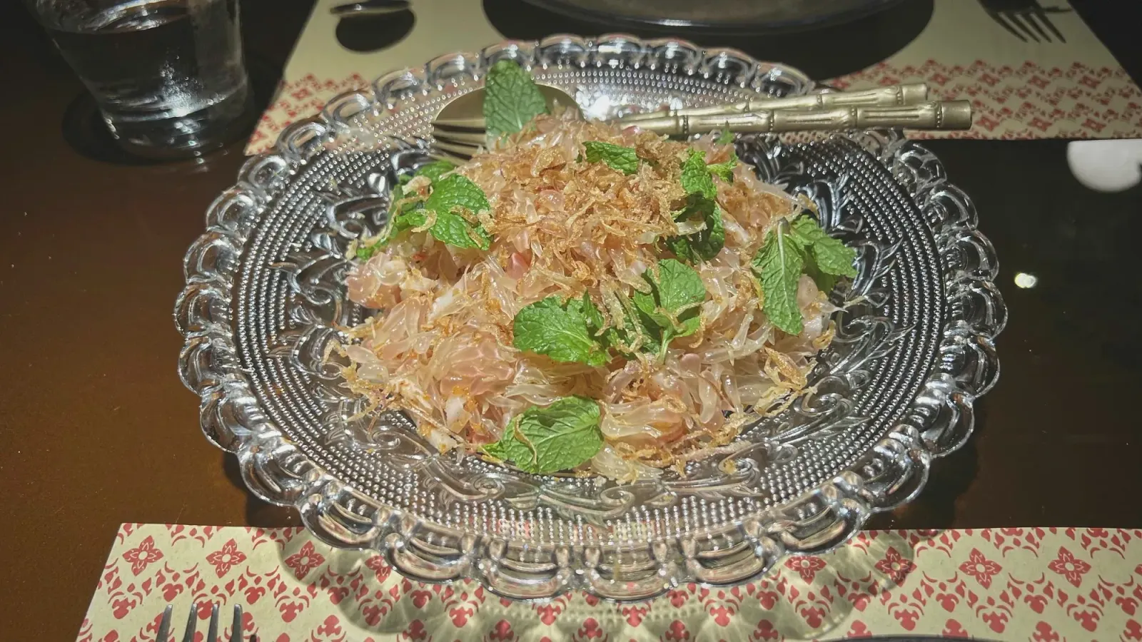 Pomelo Salad by Mr. Wanderer Pomelo salad served on a glass plate.