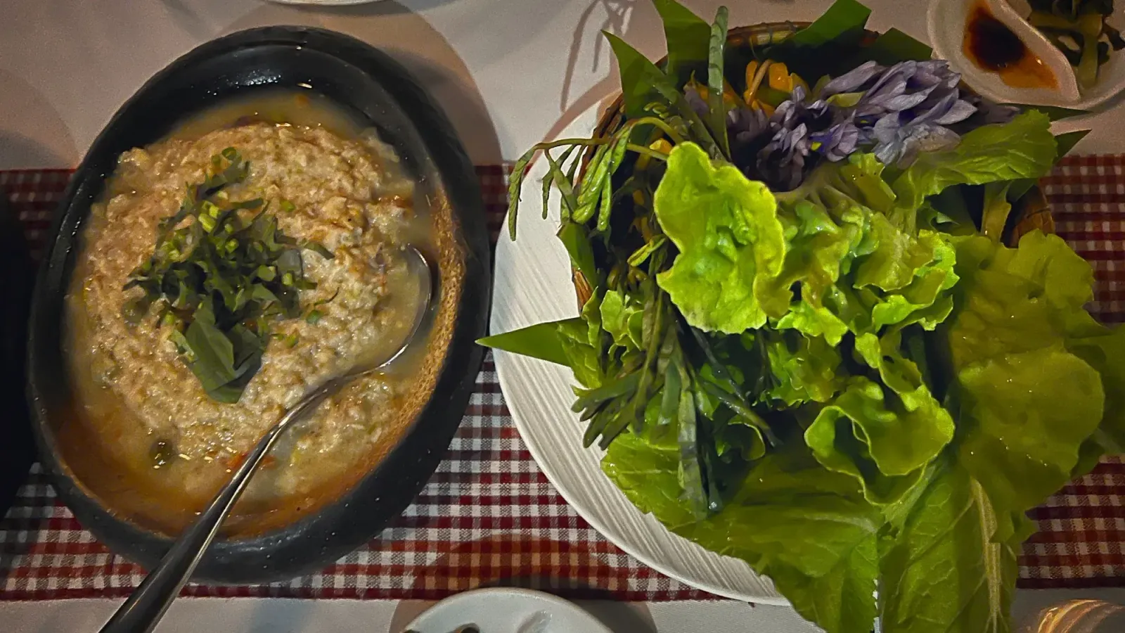 Tek Kreoung by Mr. Wanderer Plate of Tek Kroeung served with fresh greens and flowers.