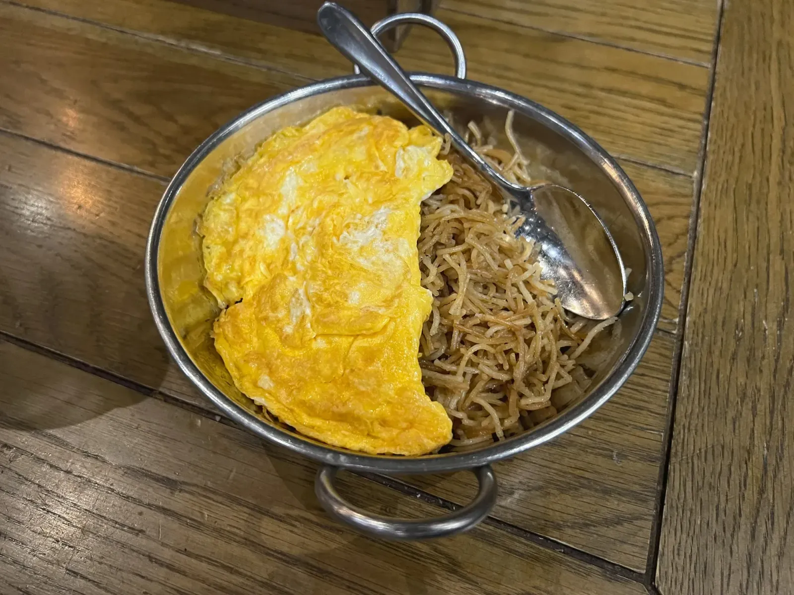 Balaleet by Mr. Wanderer Bowl of Balaleet, angled shot. Vermicelli noodles half covered by egg.
