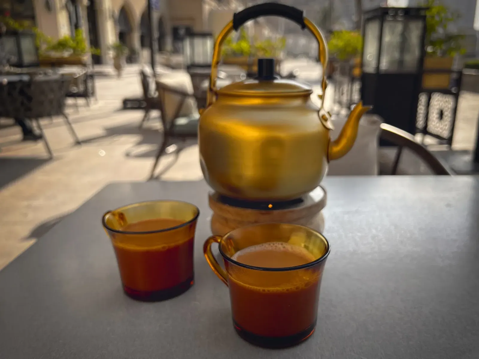 Karak Tea by Mr. Wanderer A pot and two cups of Karak tea, table shot.