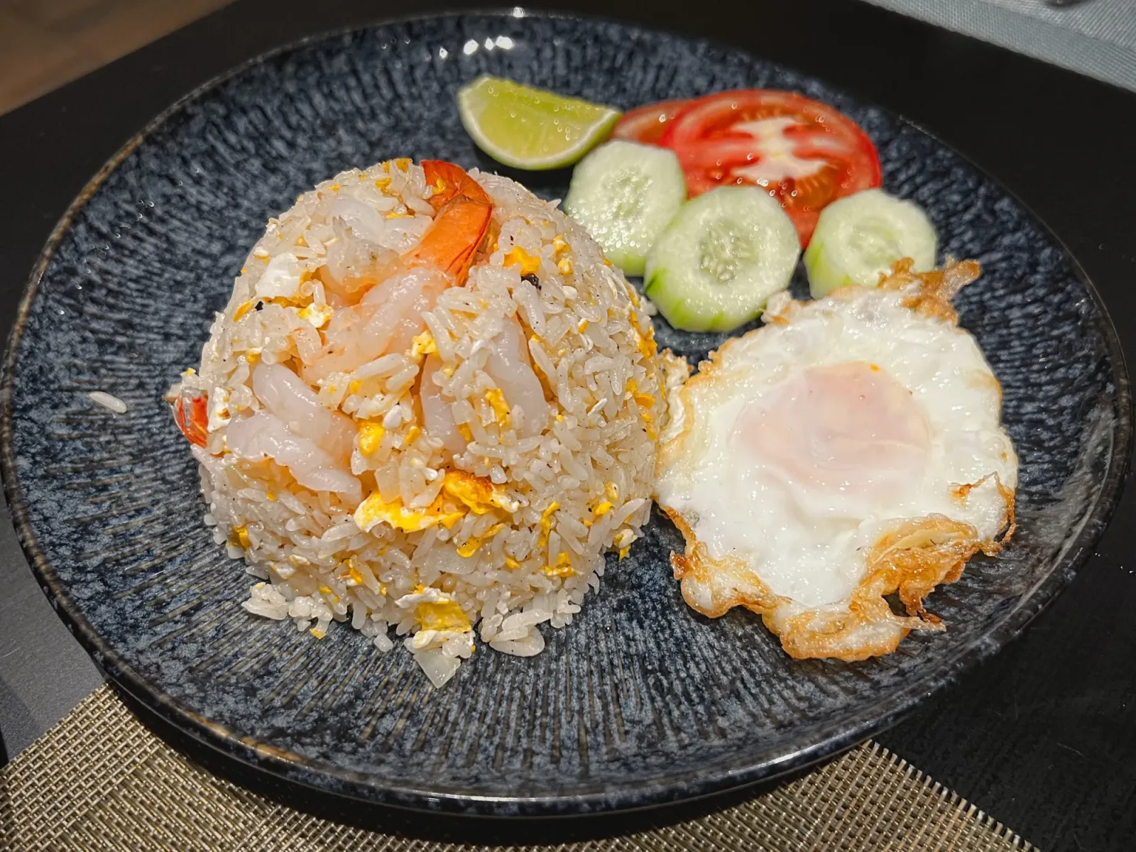 Khao Pad by Mr. Wanderer Plate with shrimp fried rice and a whole fried egg.