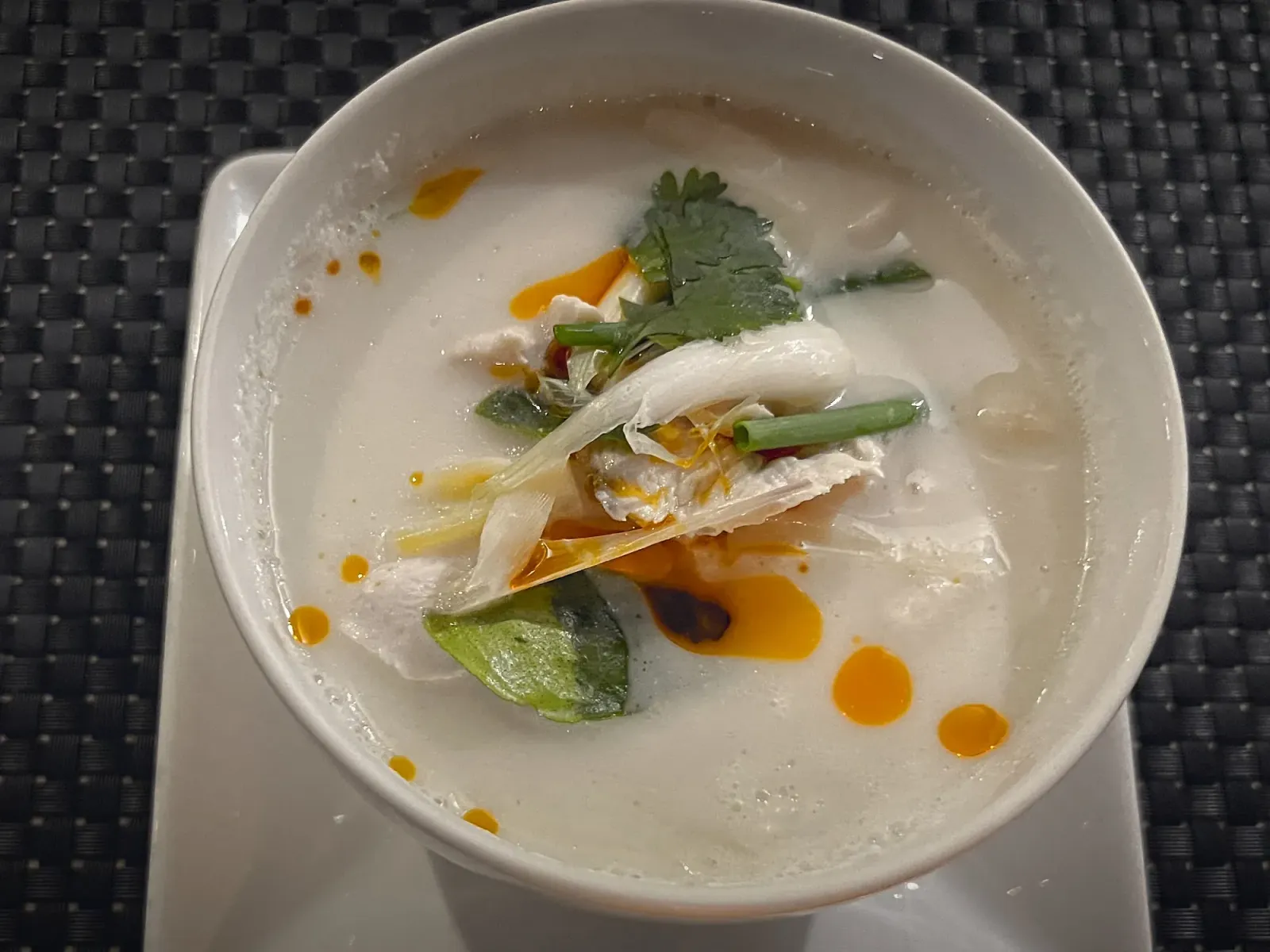 Tom Kha by Mr. Wanderer Tom Kha Gai in a bowl, overhead shot.