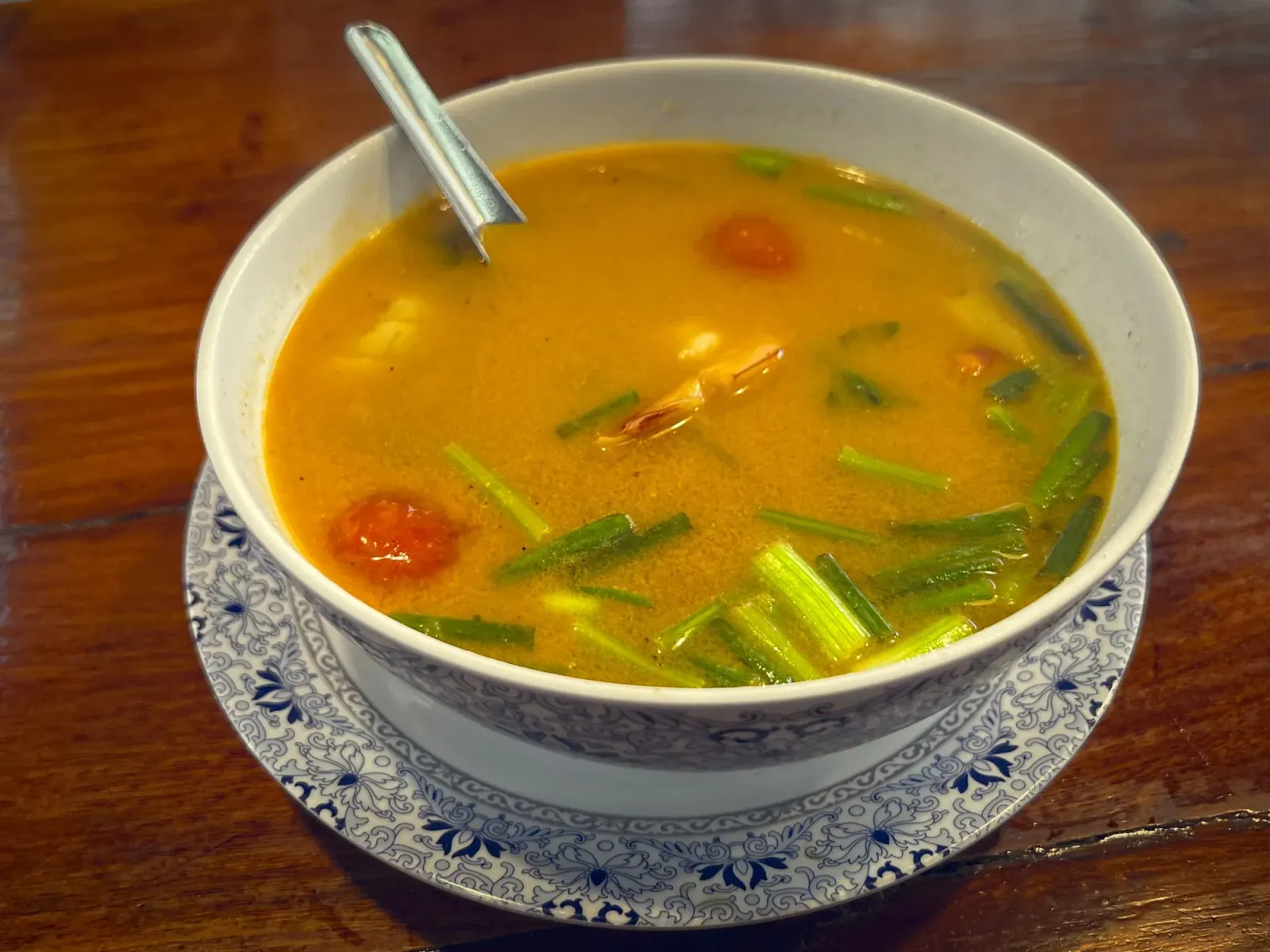 Tom Yum by Mr. Wanderer Tom Yum in a bowl, angled shot.