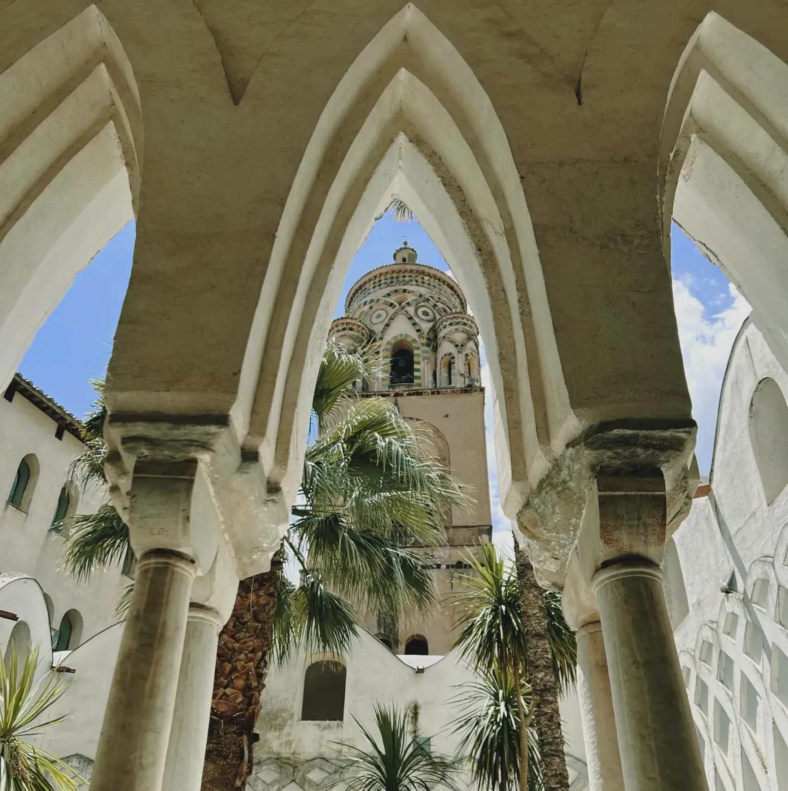 Duomo di Amalfi by Mr. Wanderer Artsy shot of the Amalfi cathedral's steeple, framed between pointed arches and columns.