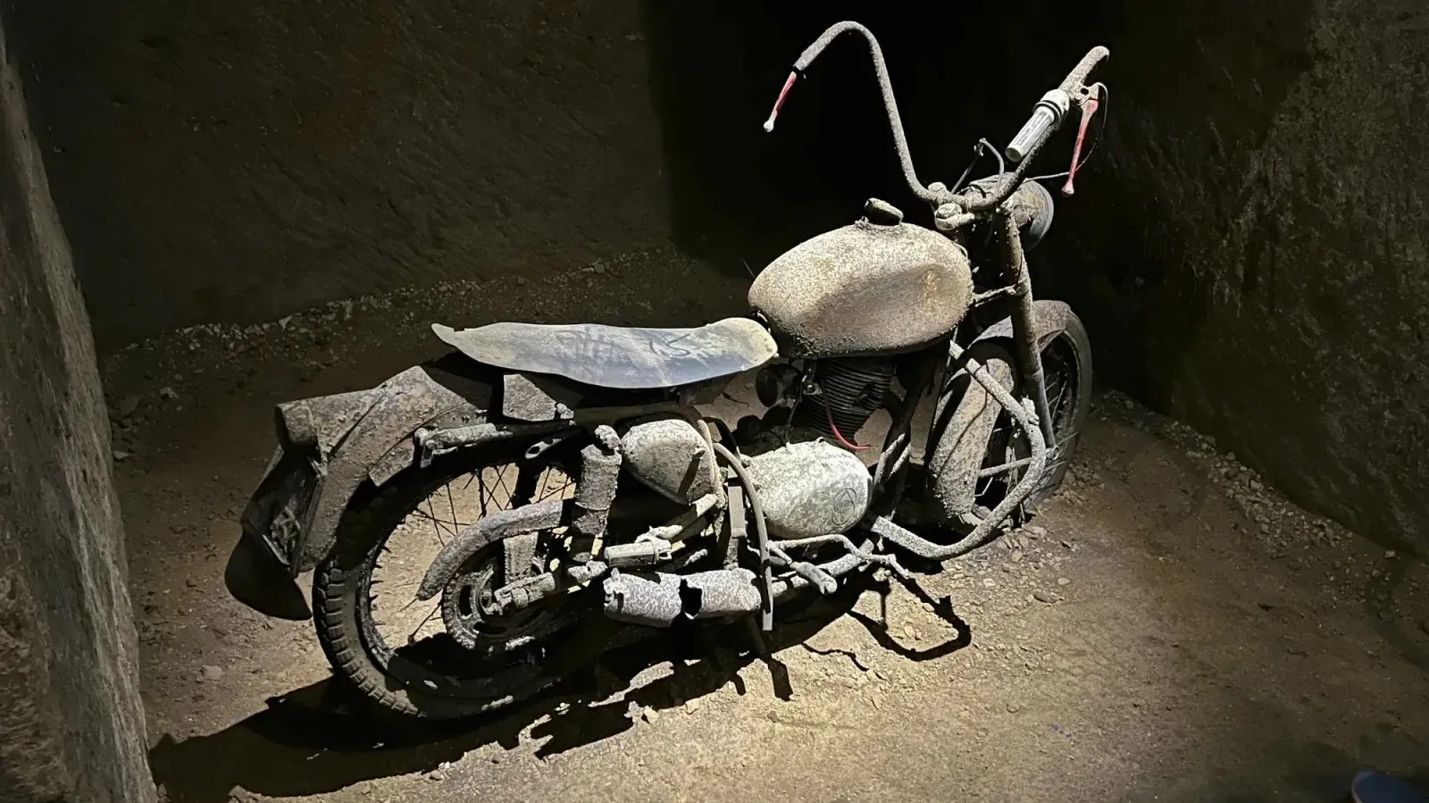 Galleria Borbonica by Mr. Wanderer Rusty motorbike lit by an overhead spotlight in the Bourbon Tunnels.