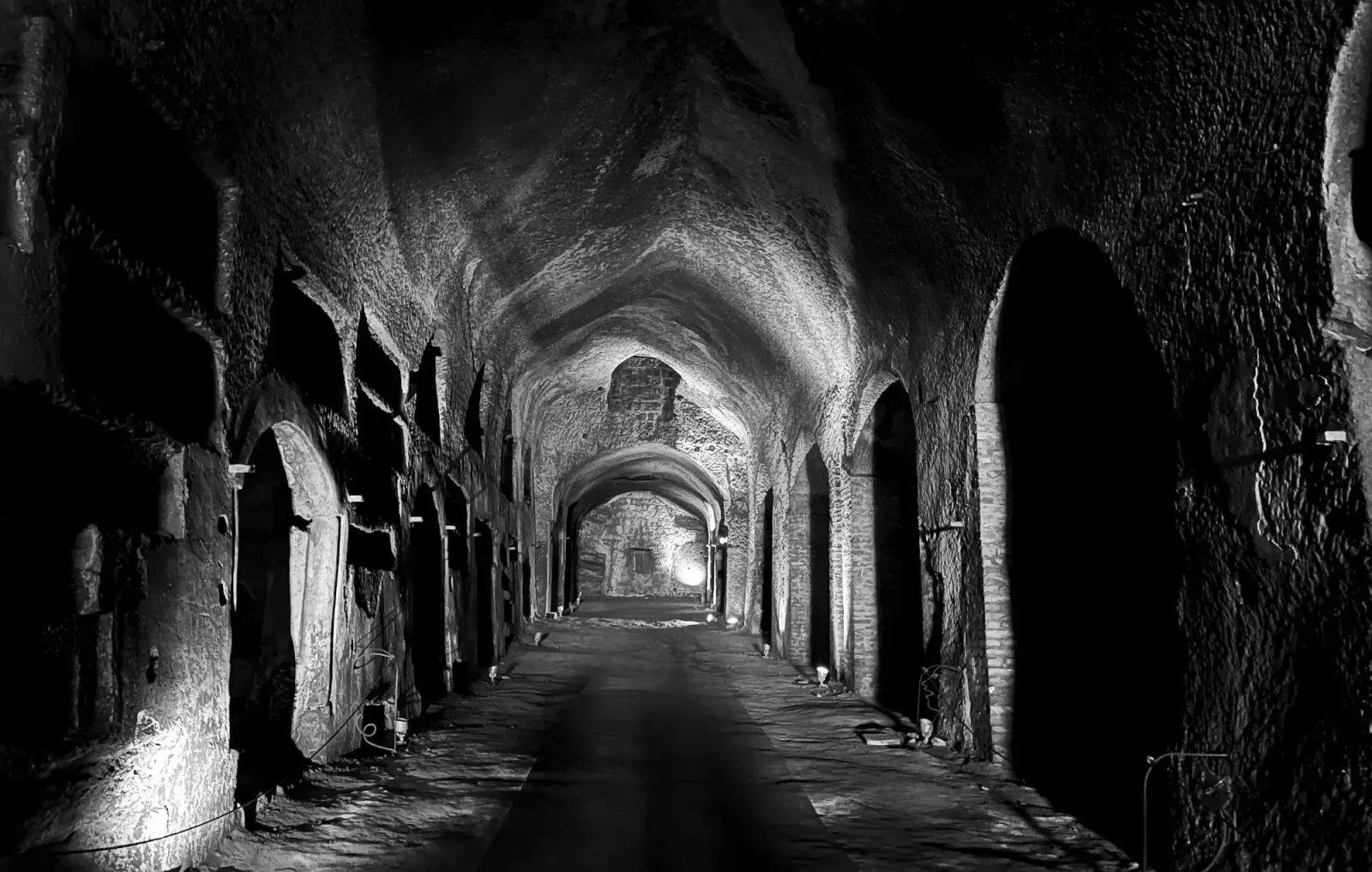 Catacombe di San Gennaro by Mr. Wanderer Black and white of the main tunnel in Catacombe di San Gennaro.