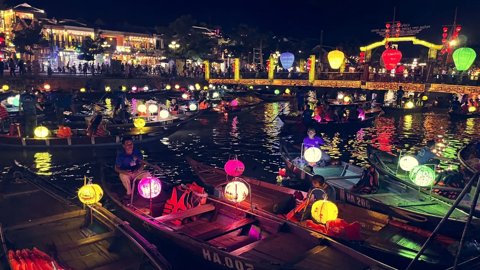 Hội An by Ms. Wanderer Hoài River with many boats and lanterns in Hội An at night.