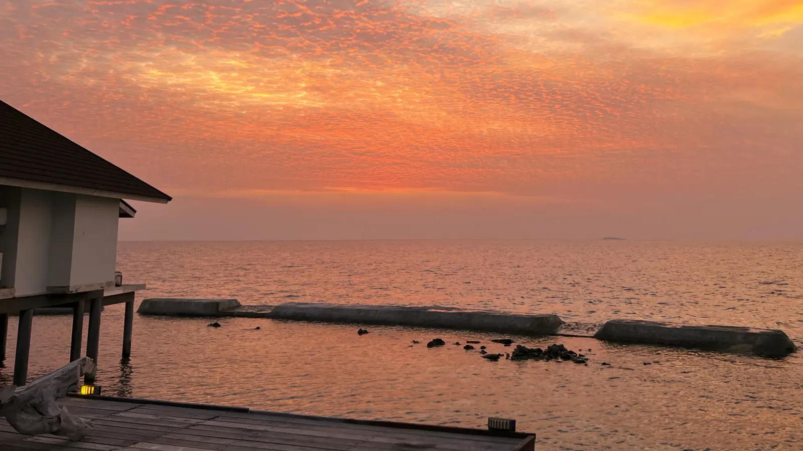 Bungalow Sunset by Mr. Wanderer Pink and orange sky reflecting in the water by the bungalows