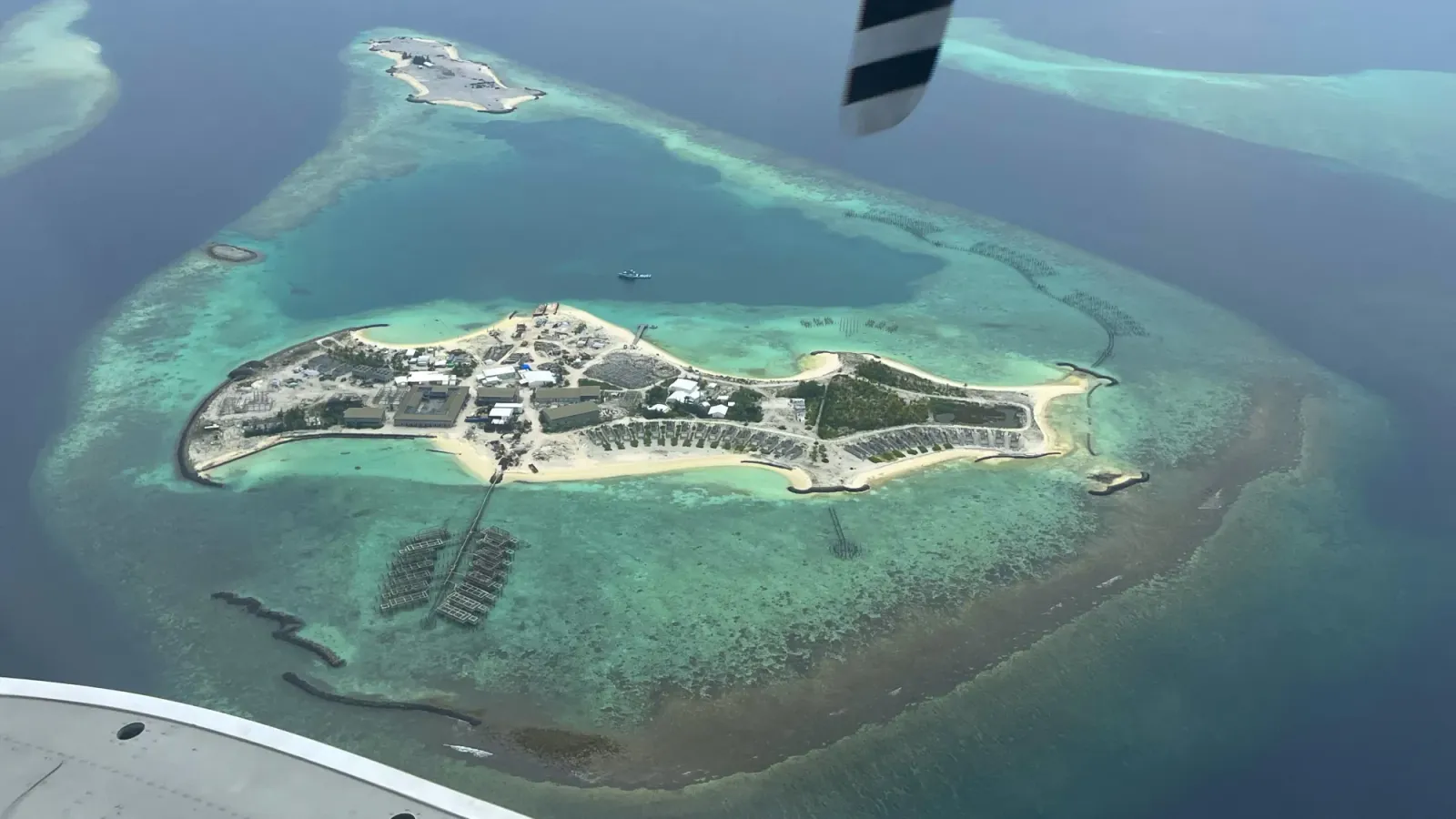 Maldivian Island by Mrs. Wanderer Aerial image of an island resort with shallow turquise water around it