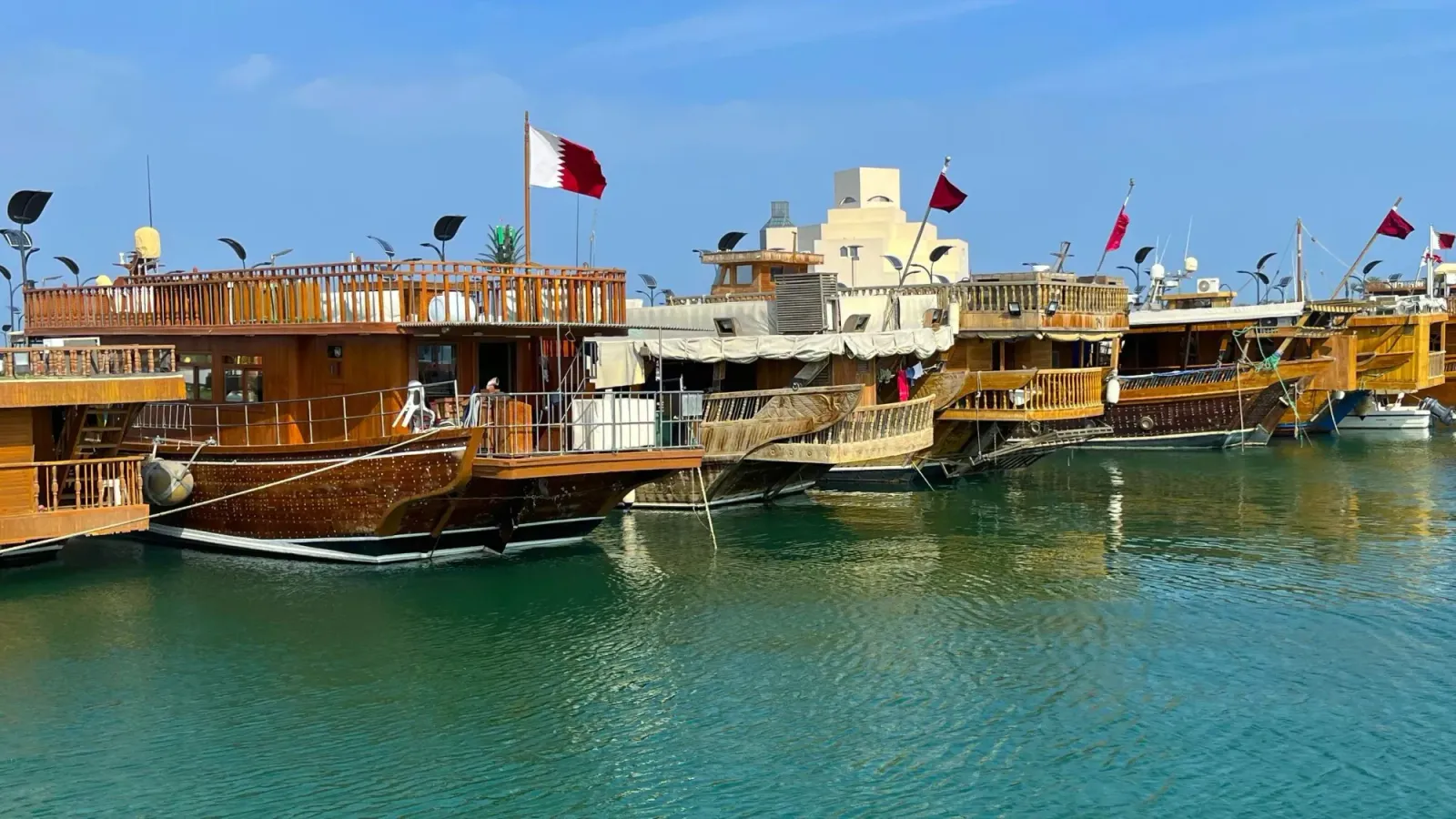 Qatari Dhows by Mrs. Wanderer A lineup of Qatari dhows flying national flags