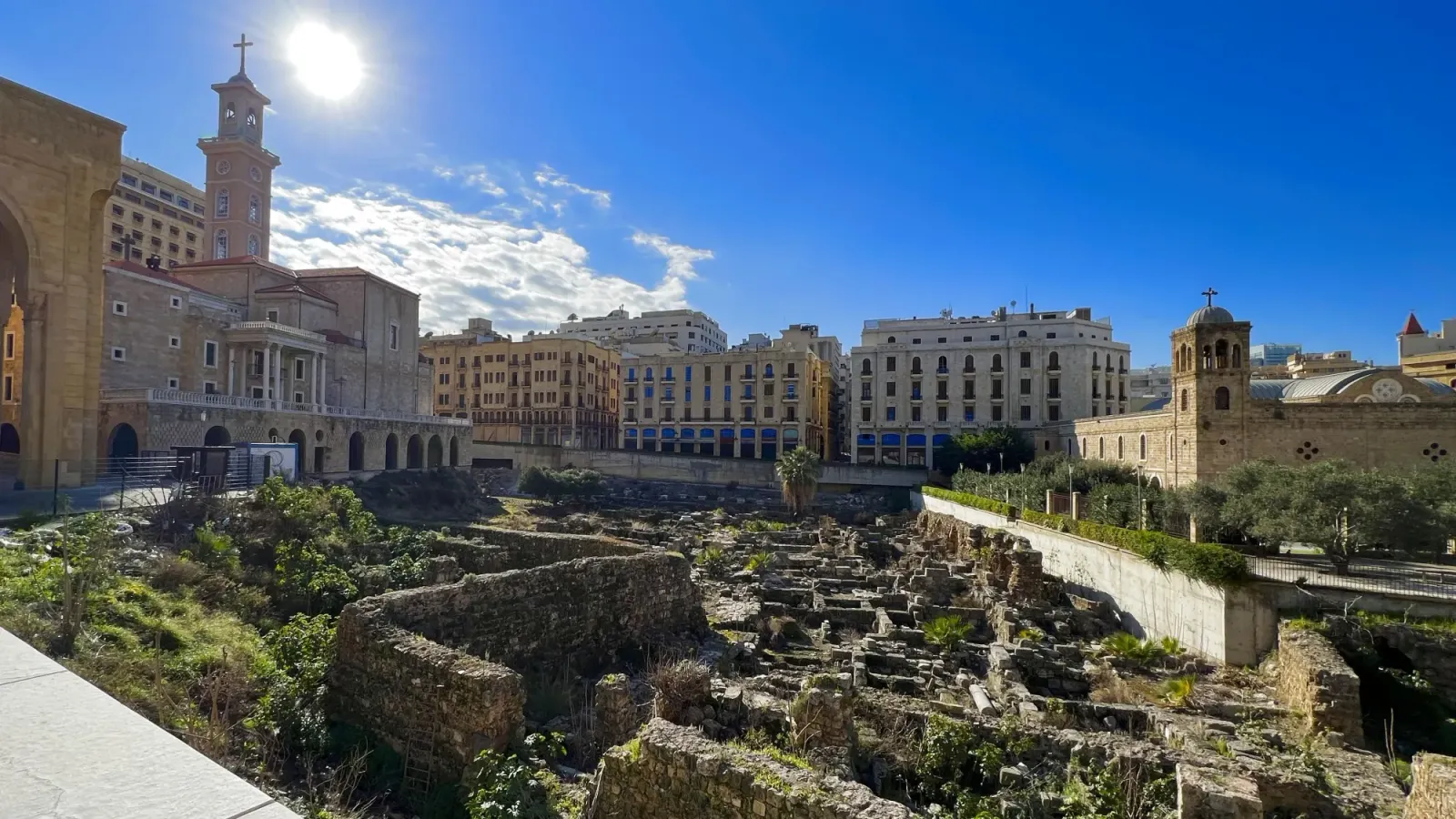 Saint George’s Greek Orthodox Cathedral by Mr. Wanderer Ruins at the foot of a tan colored church building
