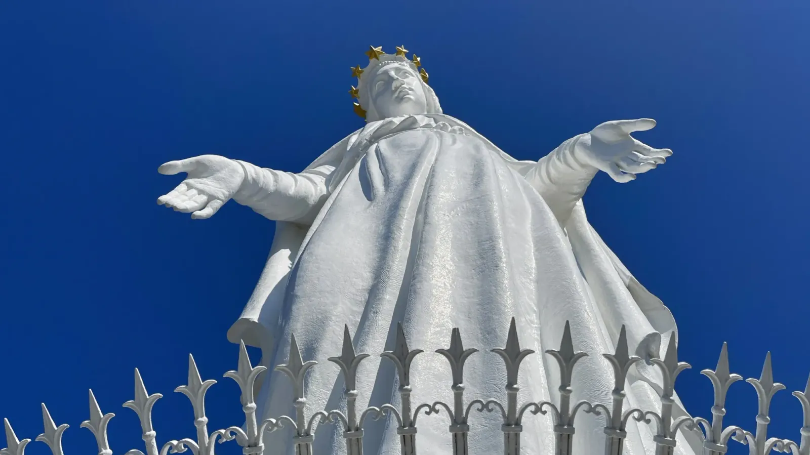 Our Lady of Lebanon by Mrs. Wanderer Looking up at the outstretched hands of the white statue of Our Lady of Lebanon
