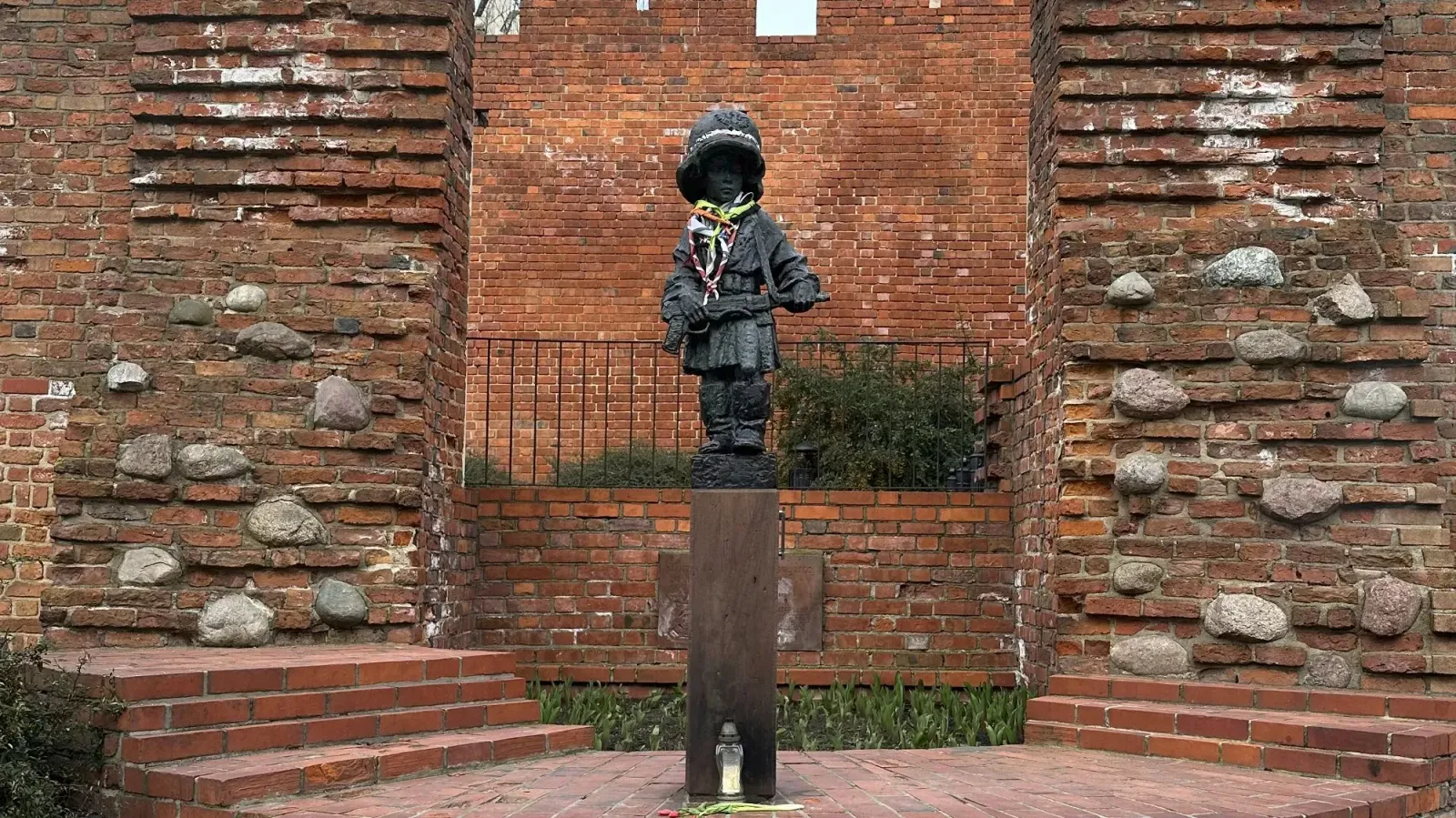 Little Insurgent by Mrs. Wanderer Statue of a little boy wearing a military helmet and carrying a weapon