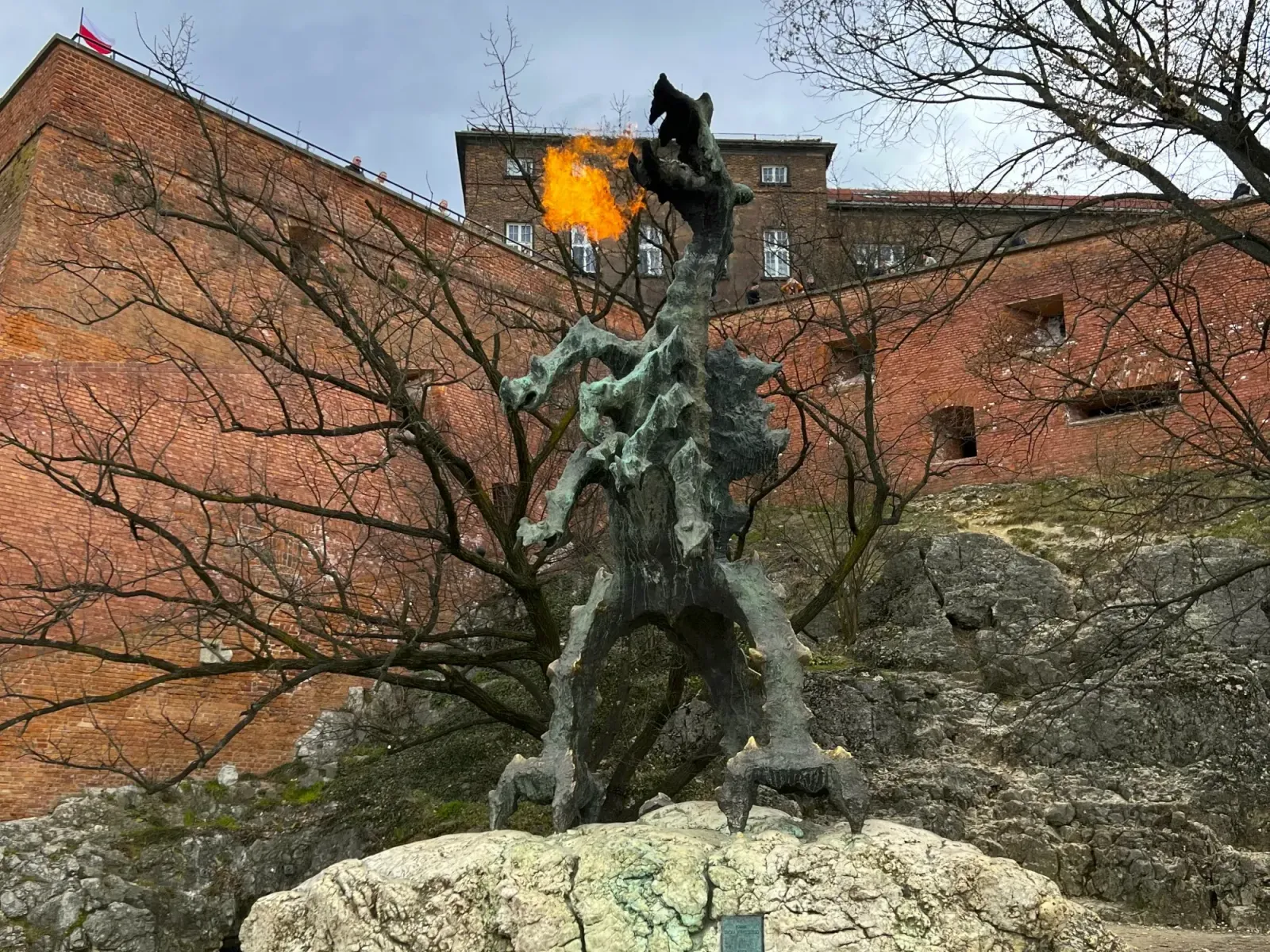 Wawel Dragon by Mrs. Wanderer Large fire breathing dragon statue in front of a brick wall