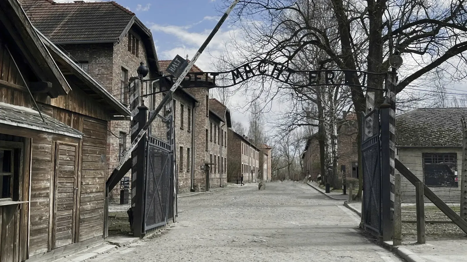 Auschwitz Work Sets You Free Gate by Mrs. Wanderer Brick buildings with a black gate with German words