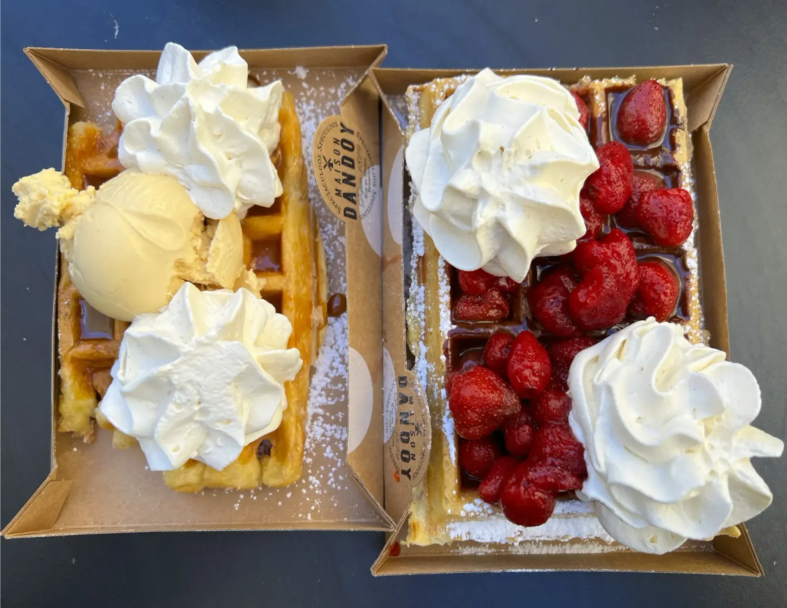Liege & Brussels Wafles by Mr.Wanderer Two waffles one with ice cream the other with berries, both covered in whipped cream