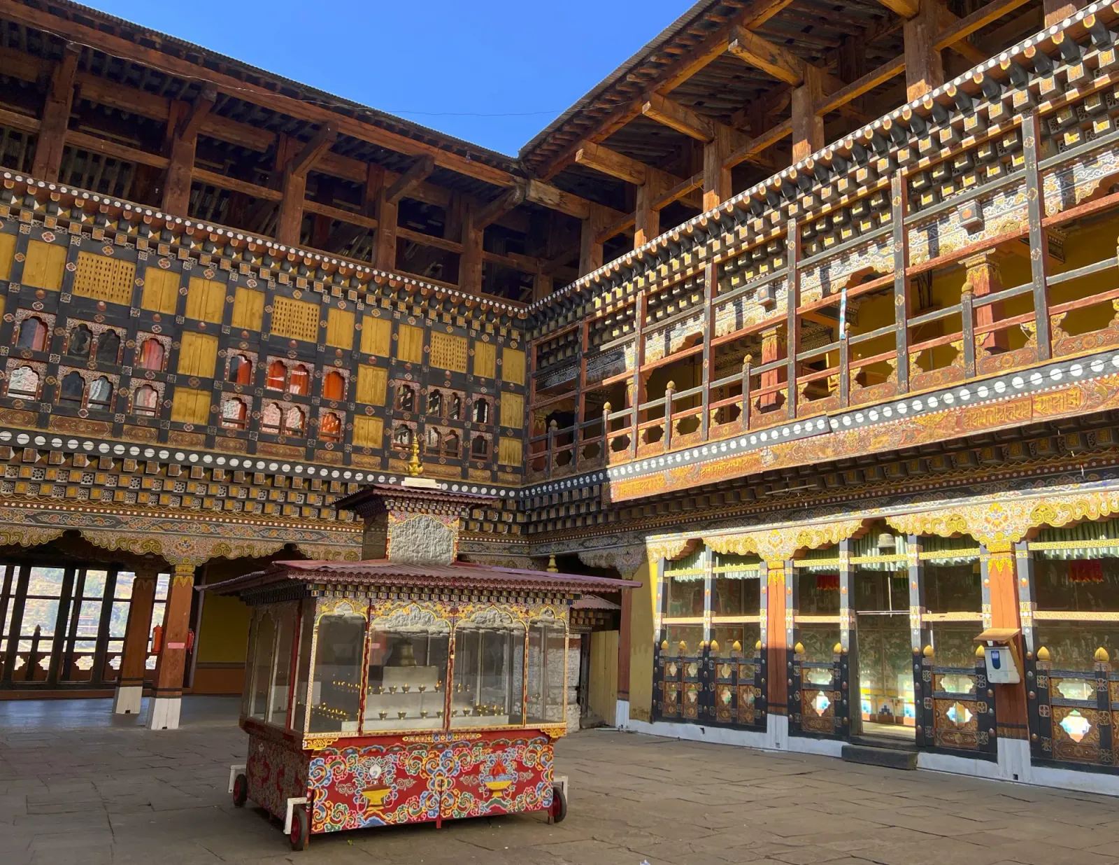 Inside Rinpung Dzong by Mr. Wanderer Wooden fort building painted in a multitude of colors
