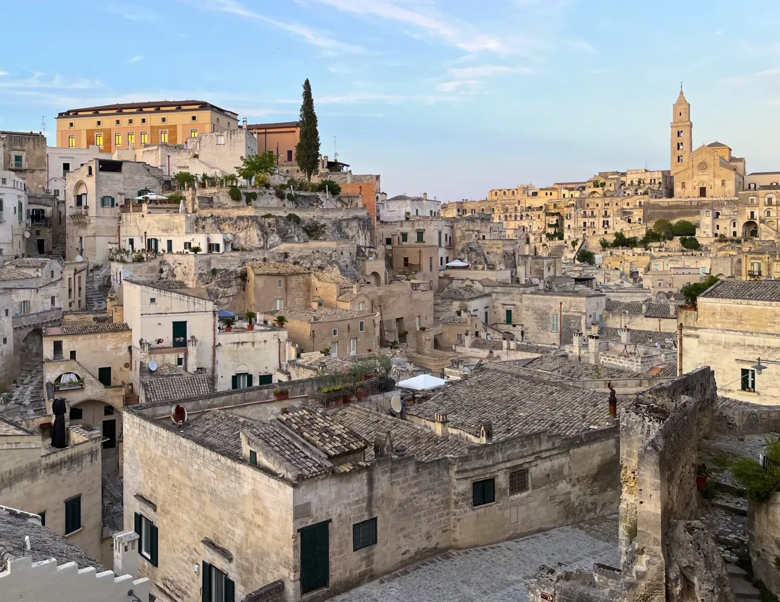 Matera Cityscape by Mr. Wanderer Tan buildings built into the side of a mountain