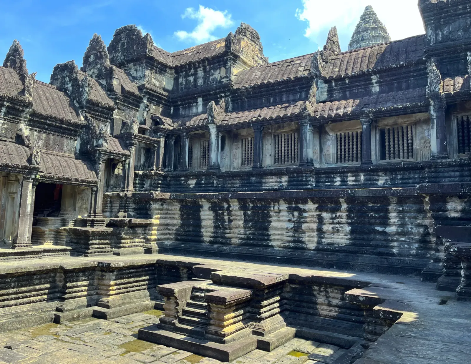 Angkor Wat Pool by Mr. Wanderer Grey stone temple with the remains of a pool