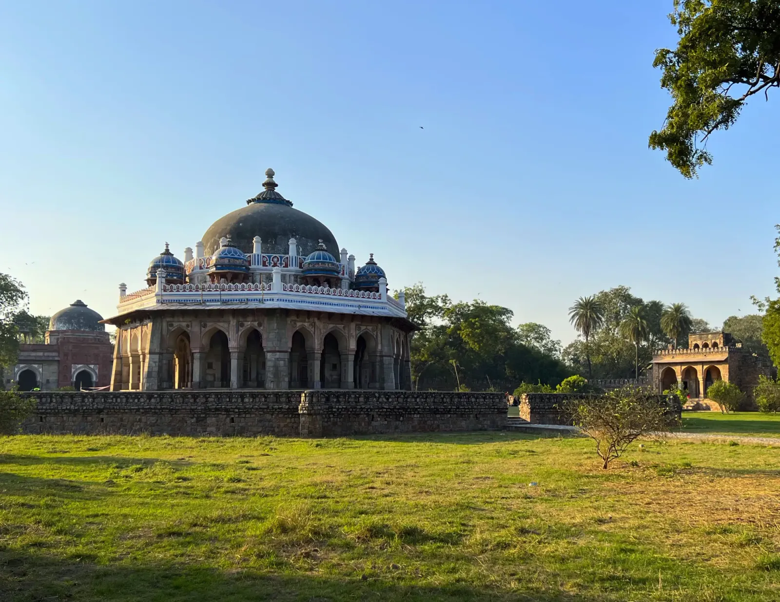 Humayun's Tomb by Mr. Wanderer Dome adorned with white decorations on a green grassy lawn