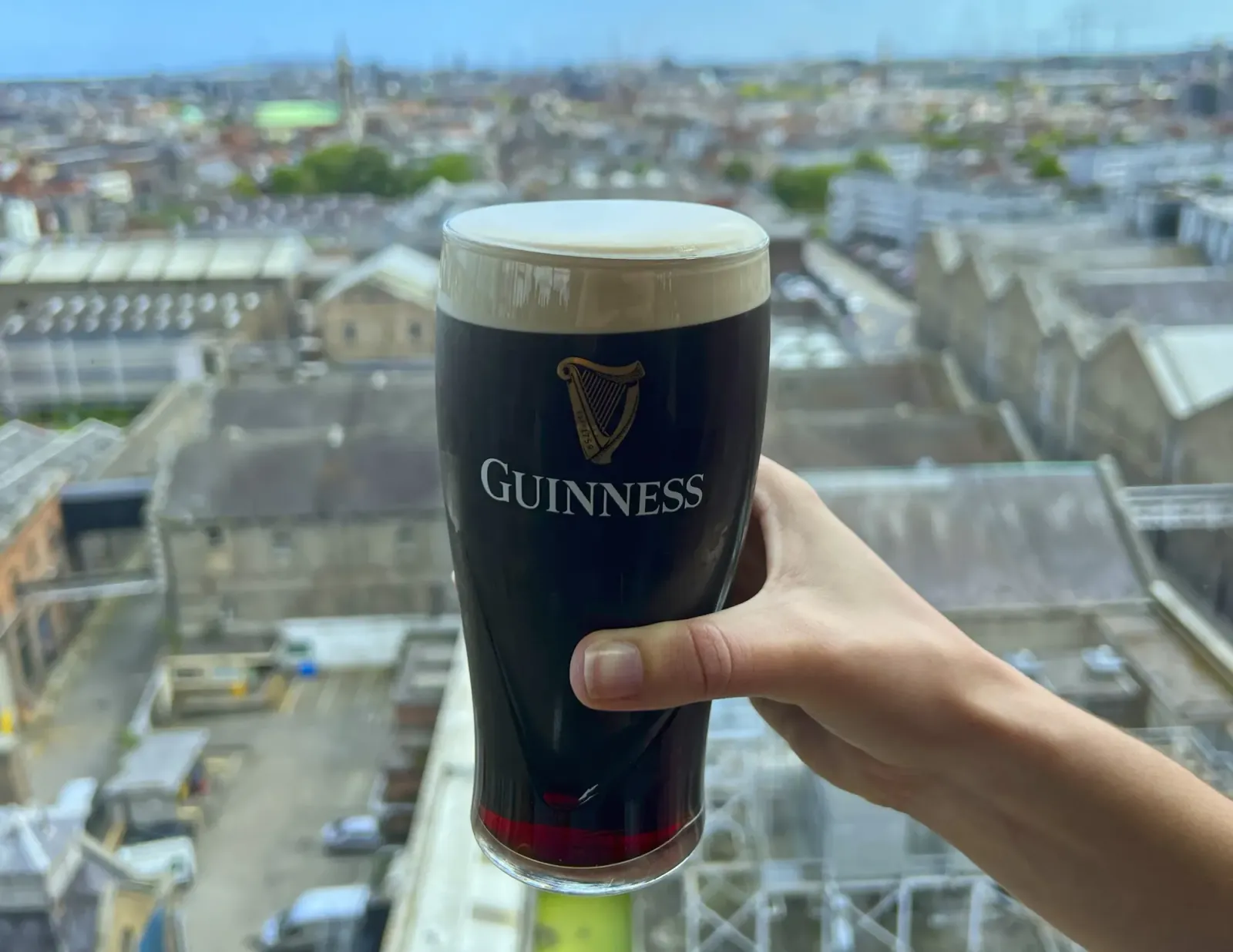 Ruby Guinness Pint by Mr. Wanderer Hand holding a pint of Guinness