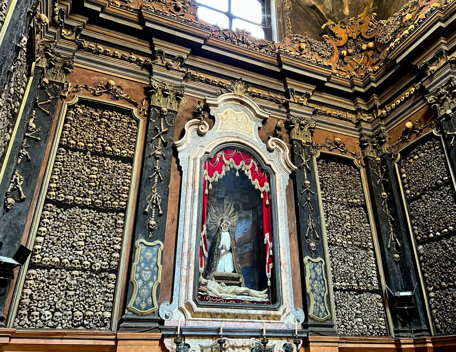 San Bernardino alle Ossa Ossuary by Mr. Wanderer Altar with walls decorated with human bones and skulls