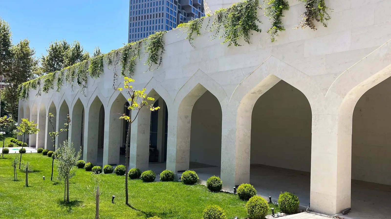 New Mosque by Mr. Wanderer White peaked areches with greenary handing from the roof