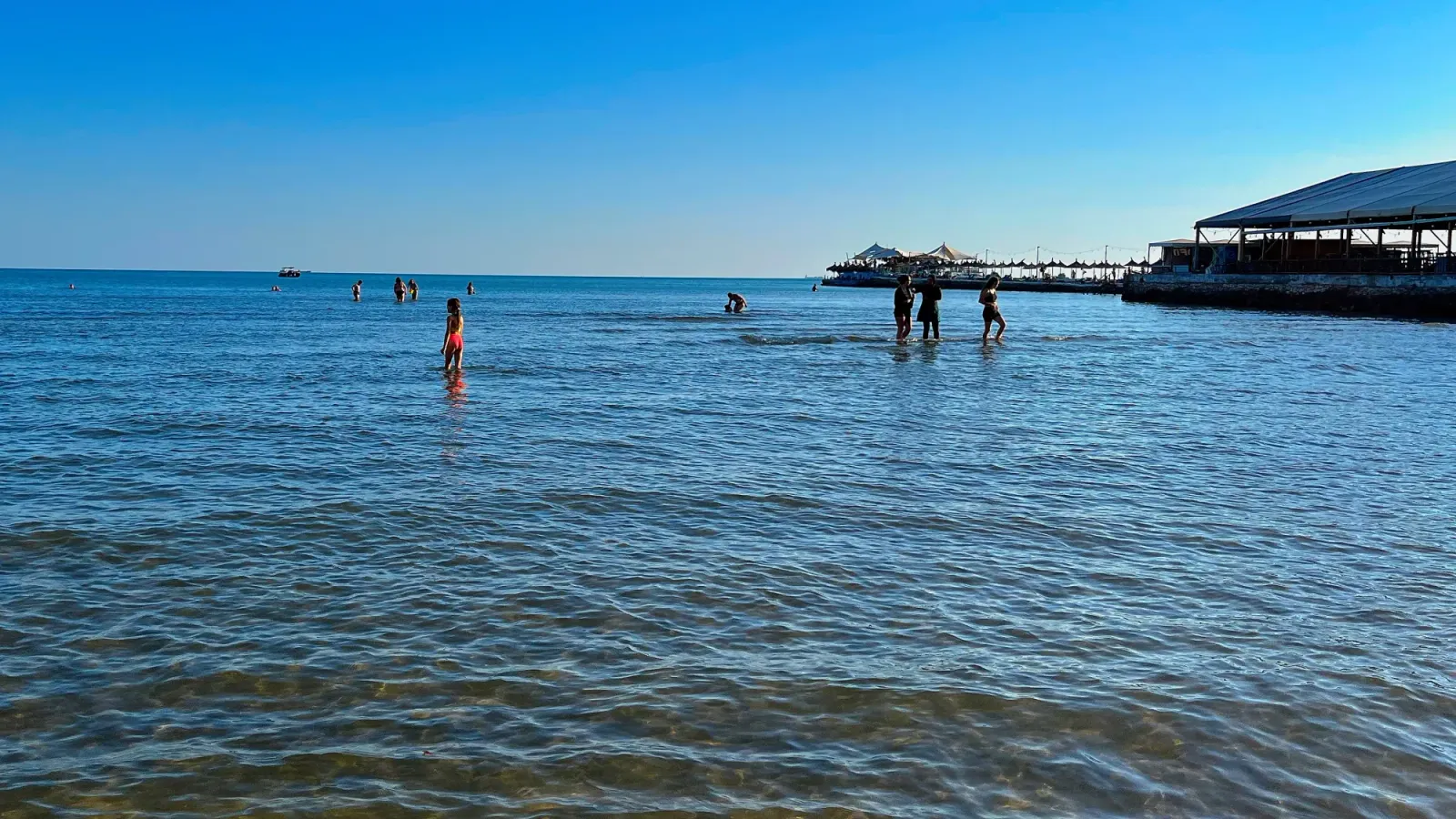 Durrës Beaches by Mrs. Wanderer Shallow beach water with families standing inside