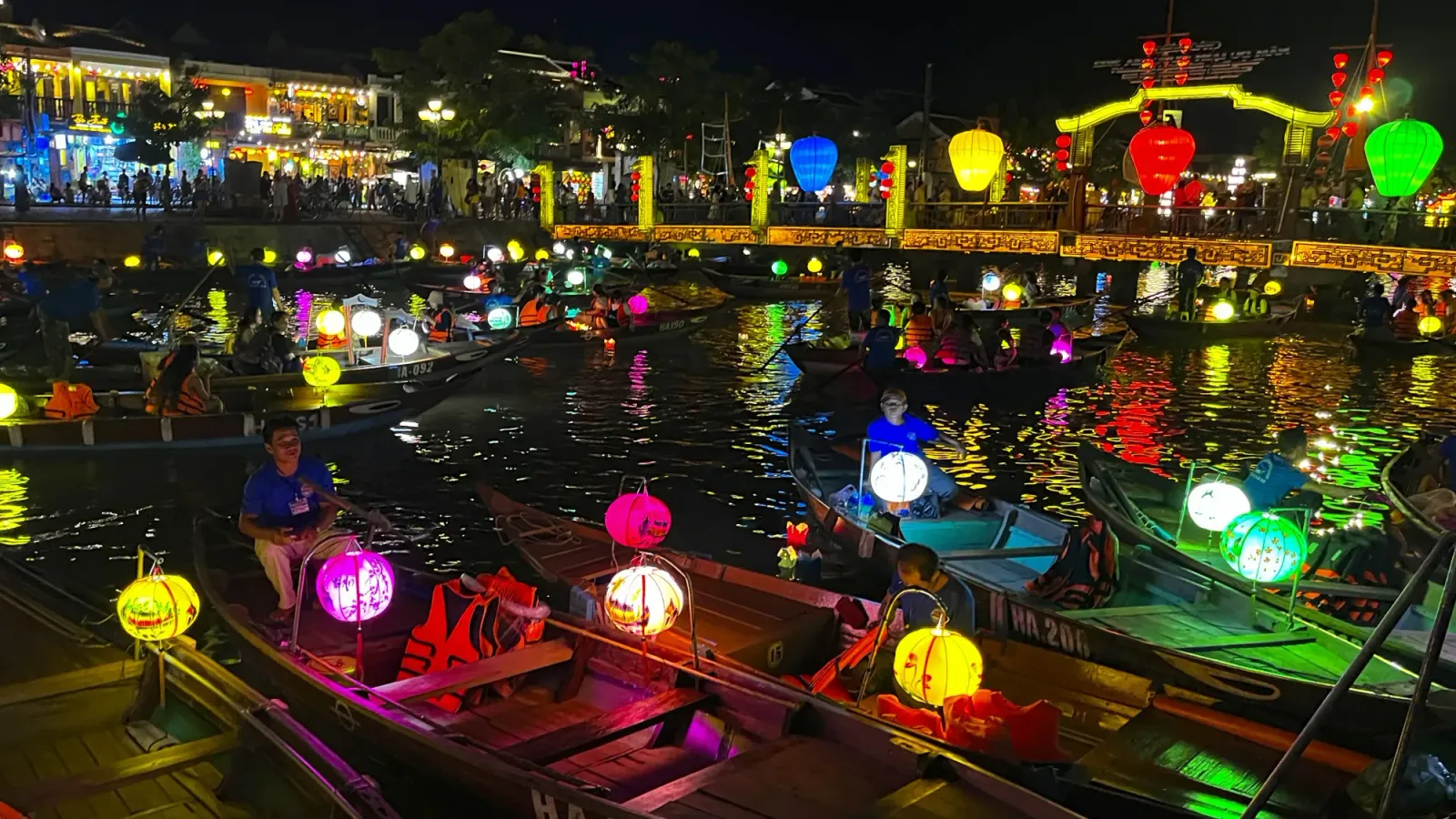 Hoi An at Night by Ms. Wanderer River and Bridge in Hoi An, Vietnam covered with colored lanterns and boats