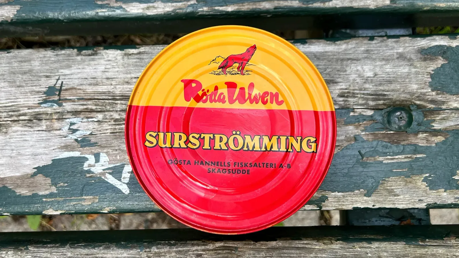 Surströmming by Mr. Wanderer Red and Yellow can on a wooden bench