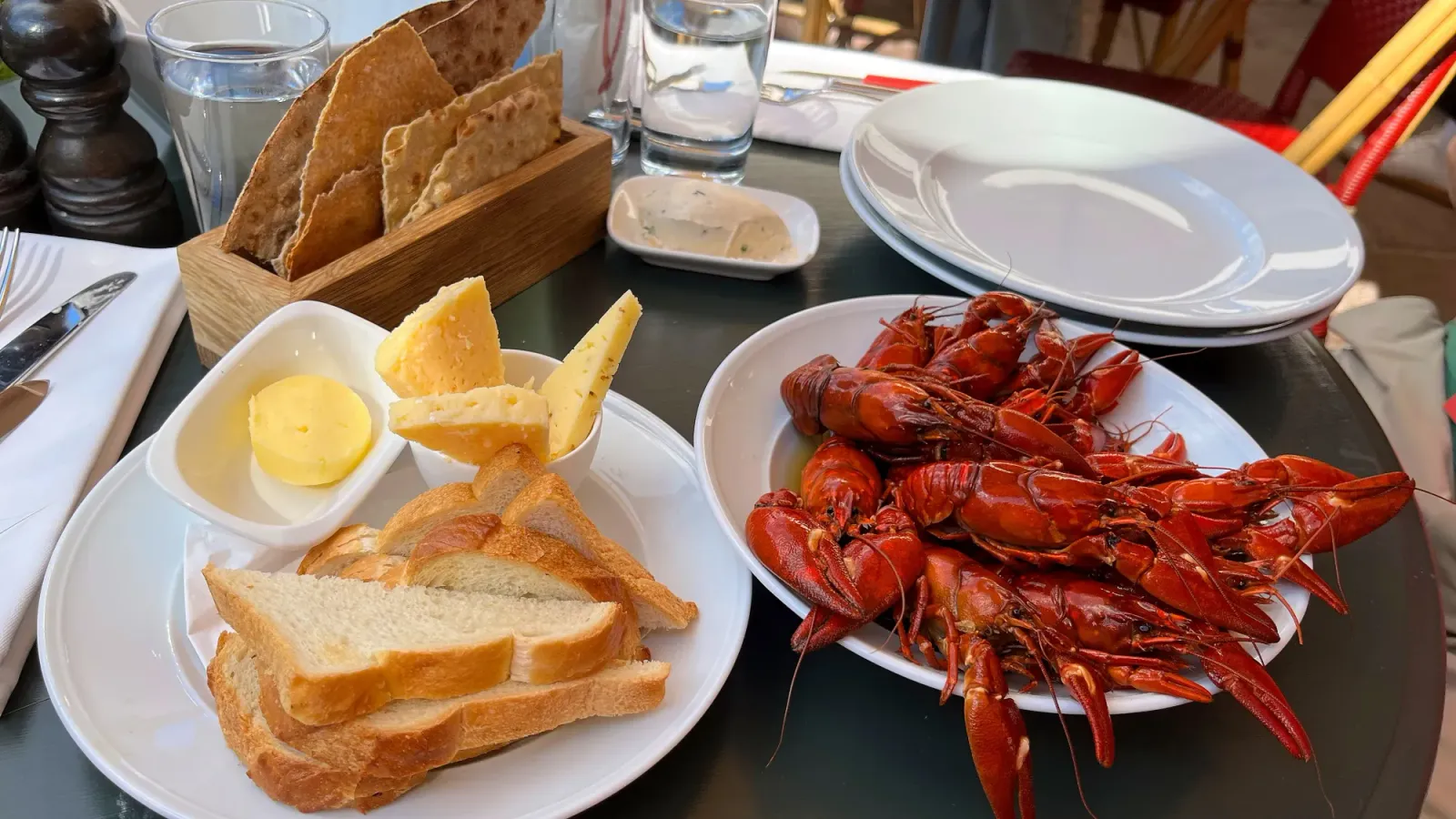 Kräftskiva by Mr. Wanderer Table set with bread, butter, cheese, crackers, and a bowl of crayfish