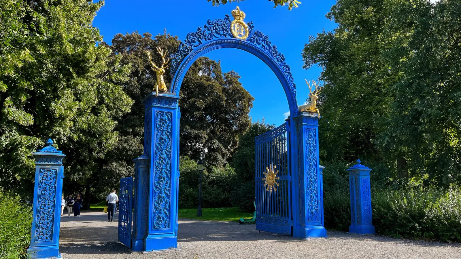 Djurgården Gate by Mrs. Wanderer Blue gate with golden stags open to a public park