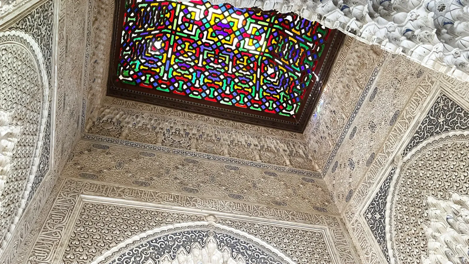 Alhambra Ceiling by Mr. Wanderer White tiled walls with red, yellow, and blue stained glass ceiling