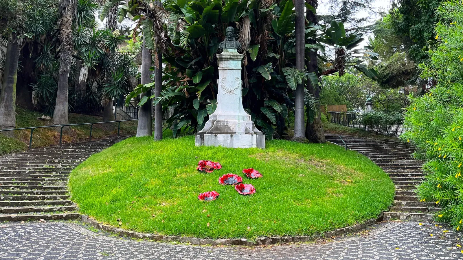 Jardim Botanico Da Universidade De Lisboa by Mrs. Wanderer Green patch of grass with stairwells on both sides
