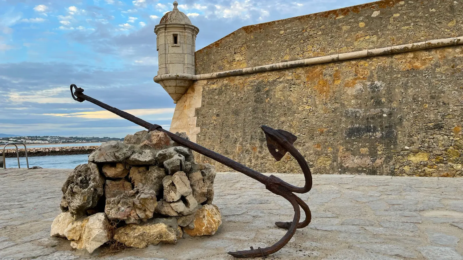 Lagos Coastline by Mrs. Wanderer Anchor in front of a stone wall