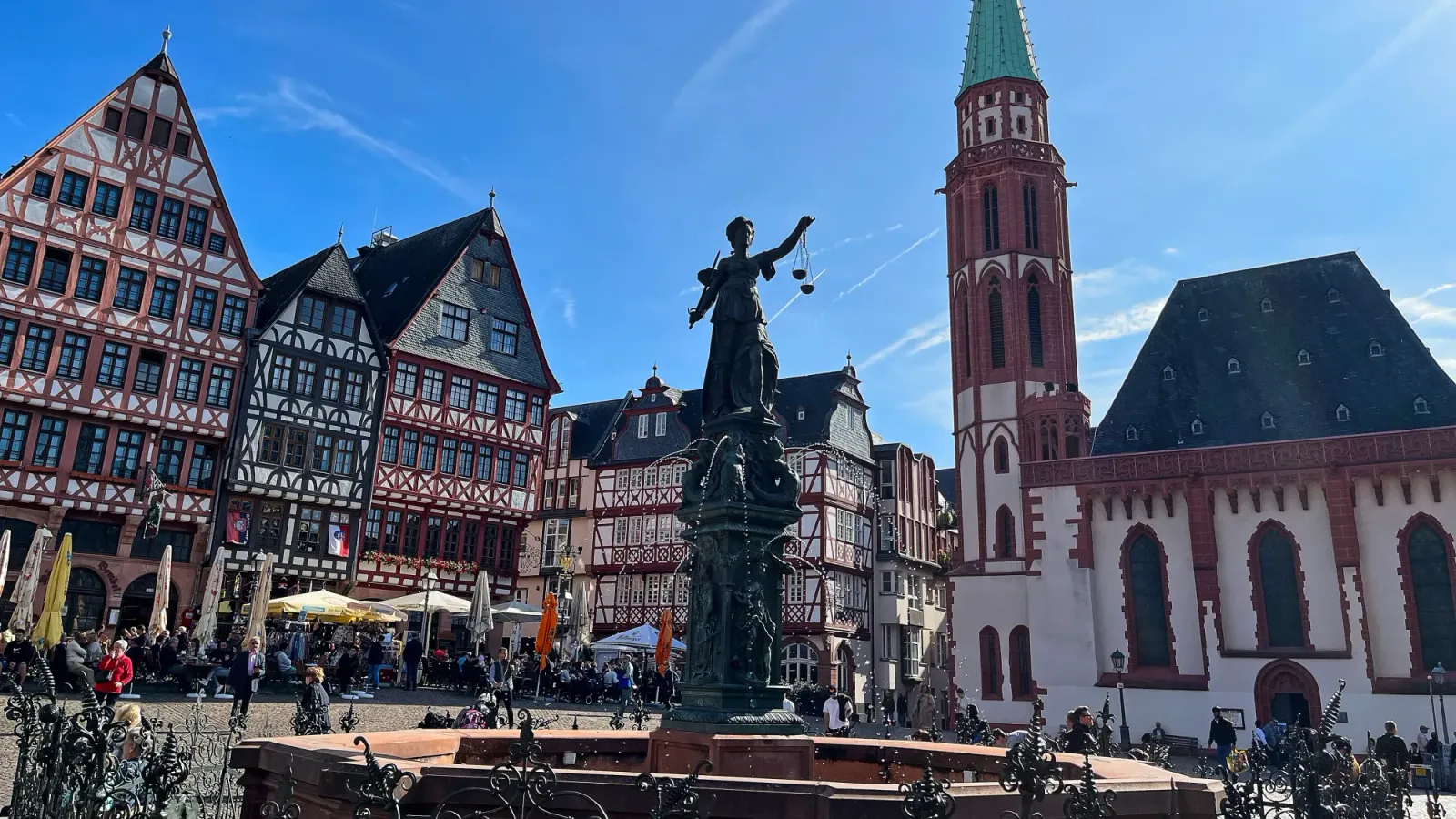 A Bavarian style plaza with a statue/fountain in the center