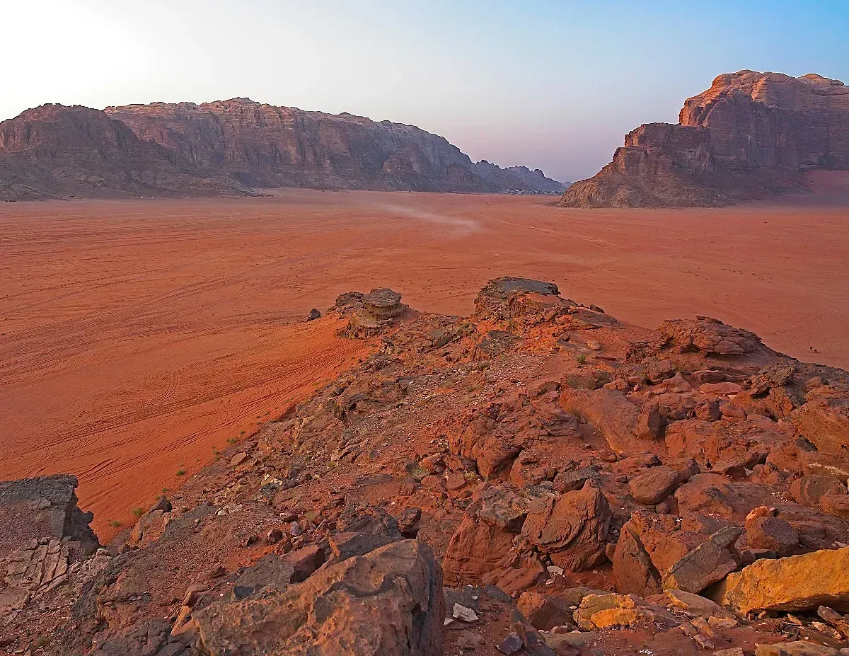 Wadi Rum by Mr. Wanderer Red-orange sand from a rocky outcrop