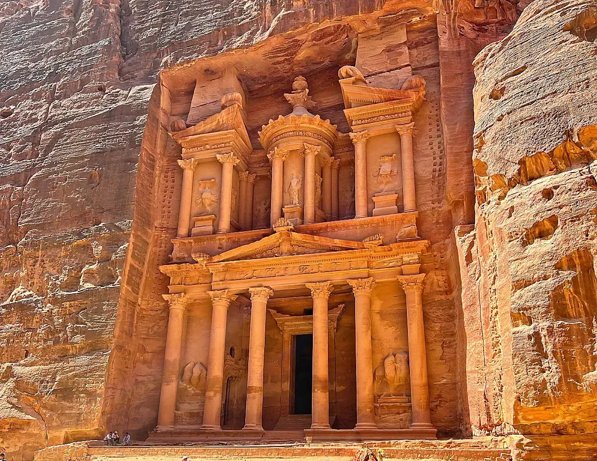 The Treasury (Al-Khazneh) by Mrs. Wanderer Iconic two story carved structure out of the orange rock face with columns and statues in tact