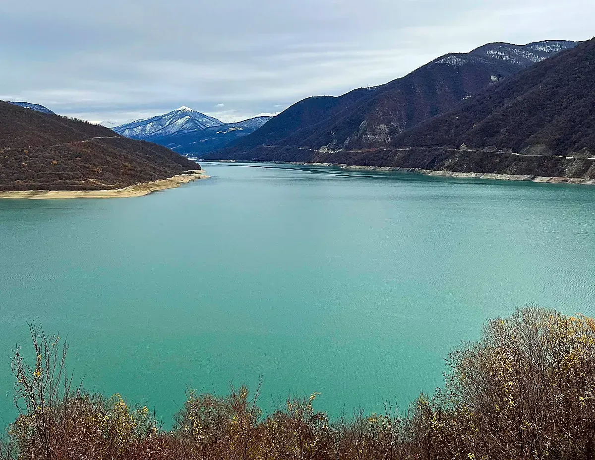 Jinvali Water Reservoir by Mrs. Wanderer Aqua colored reservoir set against tall dark mountains