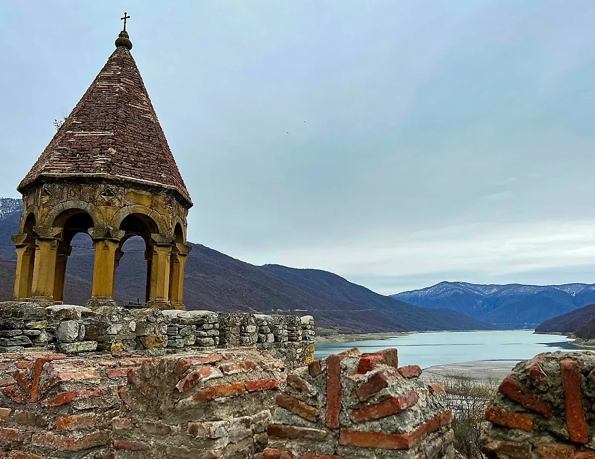Ananuri Fortress Wall by Mr. Wanderer Arched gazebo atop a stone wall overlooking a lake