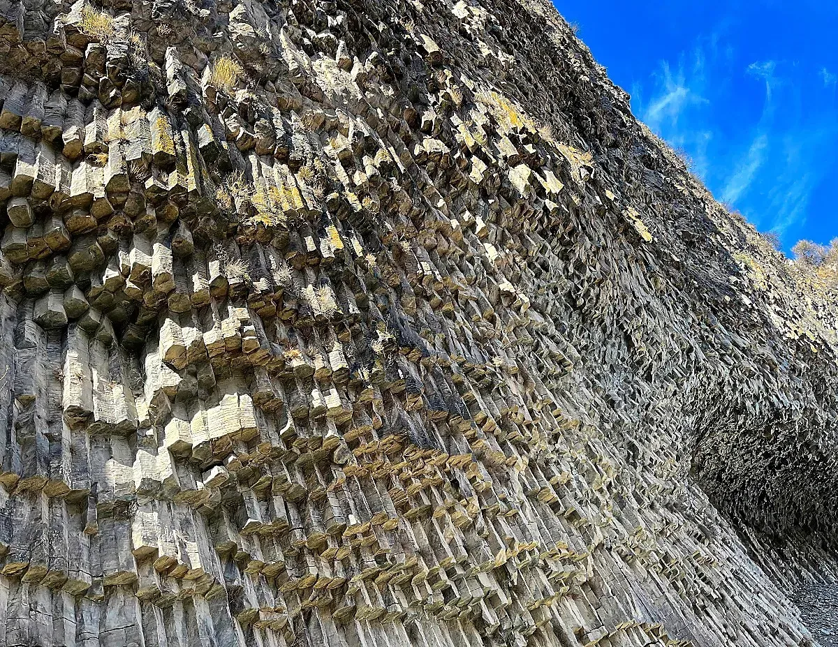 Symphony of Stone by Mrs. Wanderer Thousands of grey basalt pillars handing from the rock wall