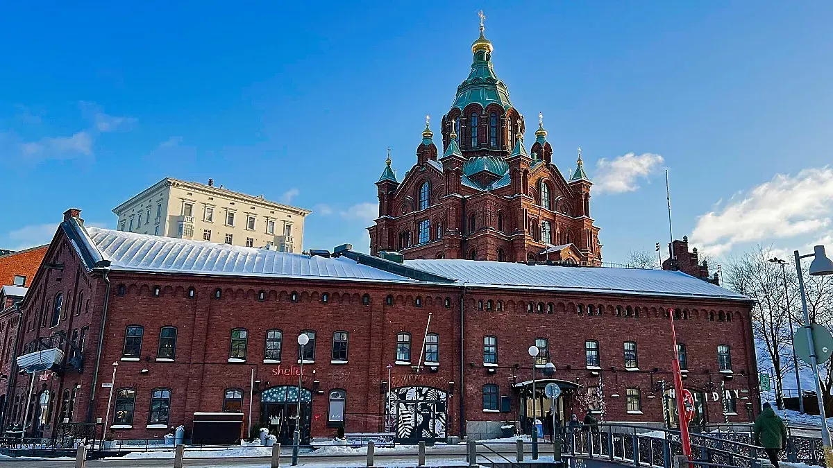 Uspenski Cathedral by Mr. Wanderer Snow covered brick building resting in front of a brick and copper church steeple