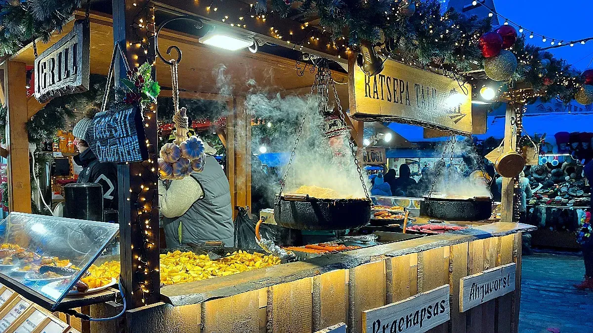 Steaming Christmas Market Stall by Mr. Wanderer Wooden stall with hanging cauldrons of food and wreaths with lights for decor