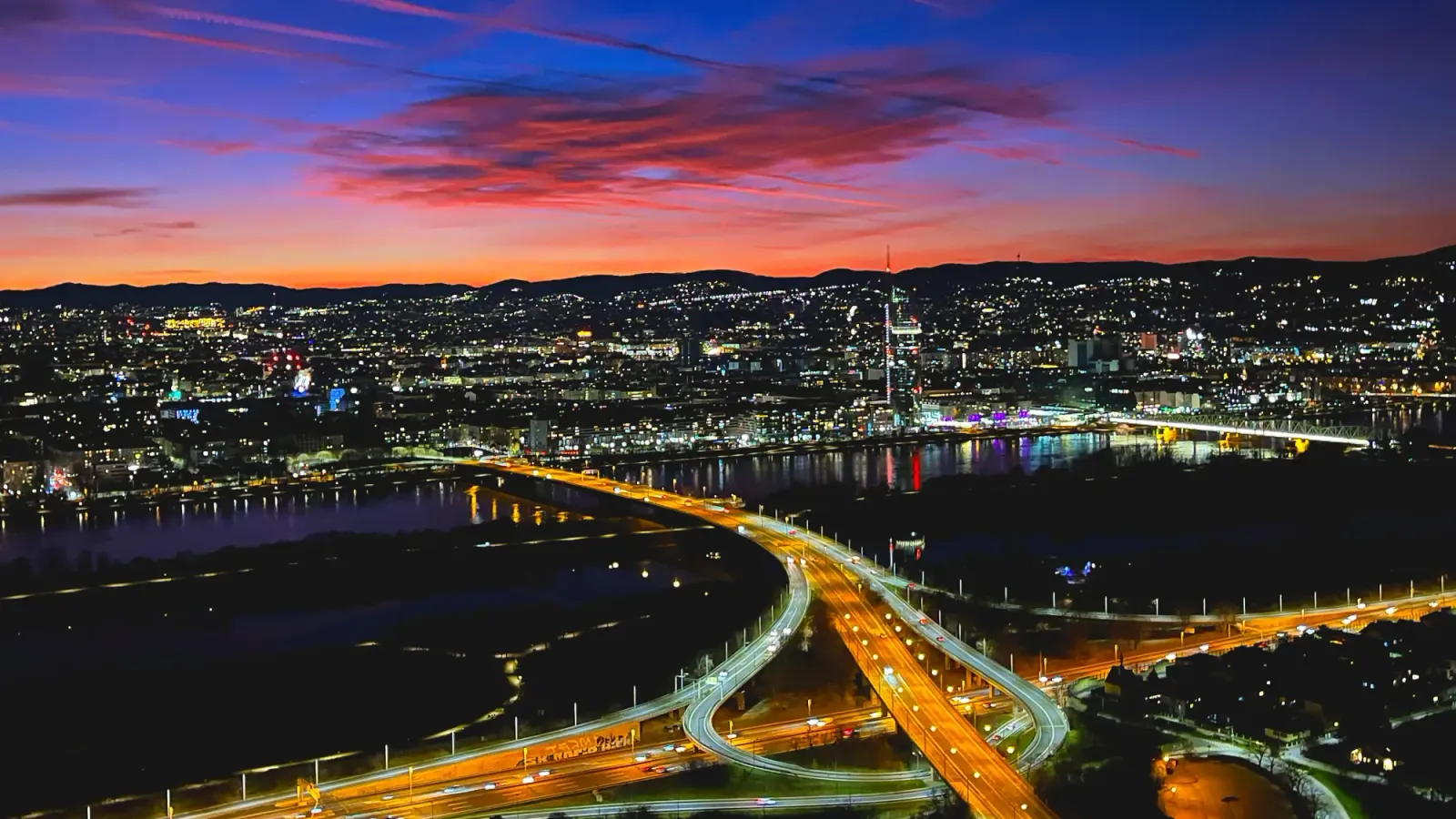 Vienna Skyline by Mrs. Wanderer The city lights just after dusk when the sky has bright colors but the buildings are dark