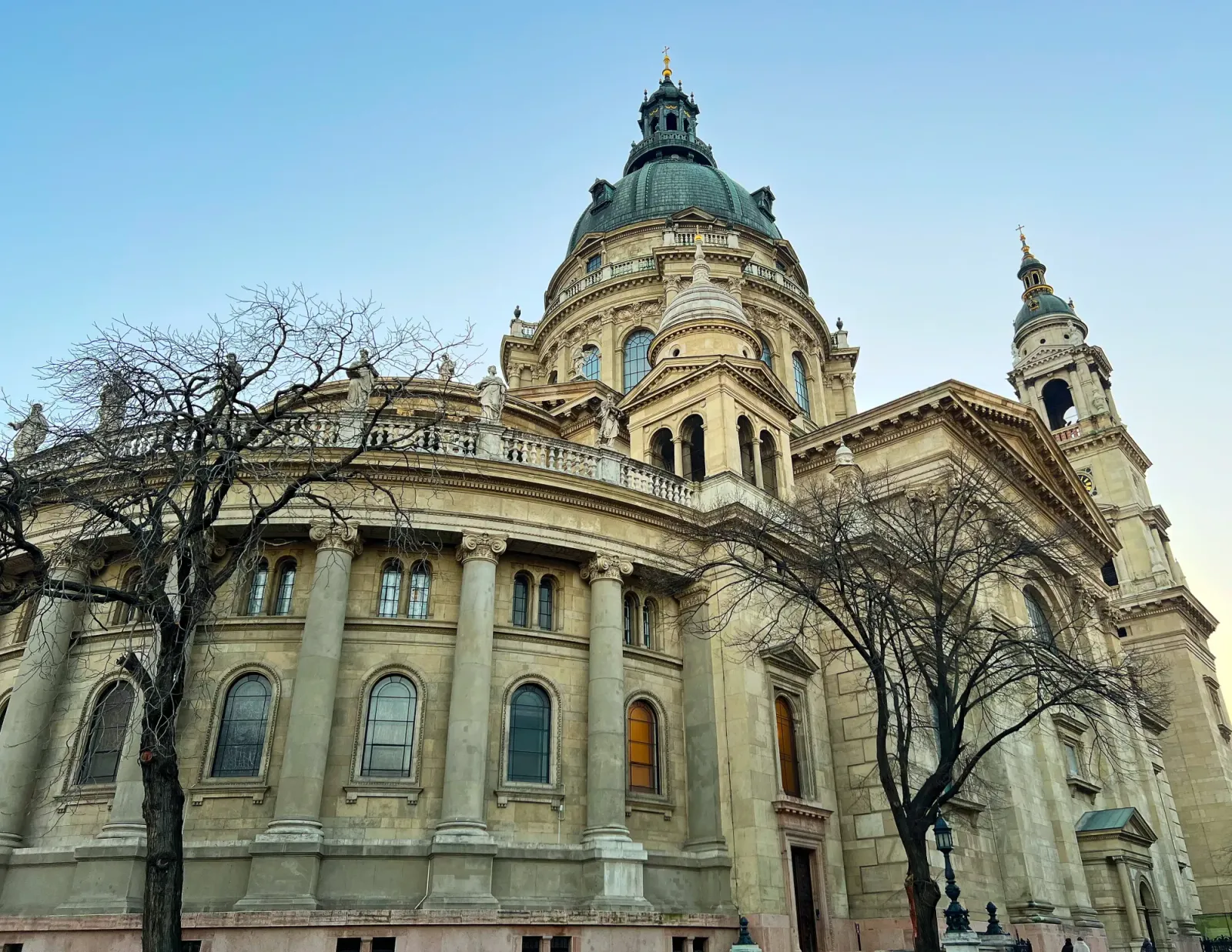 Outside St. Stephen's Basilica by Mr. Wanderer Rounded columns with statues and a green tiled roof