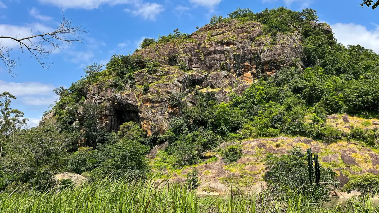 Eswatini Hillside by Mr. Wanderer Rockzy hill with bushes and grasses climbing along it