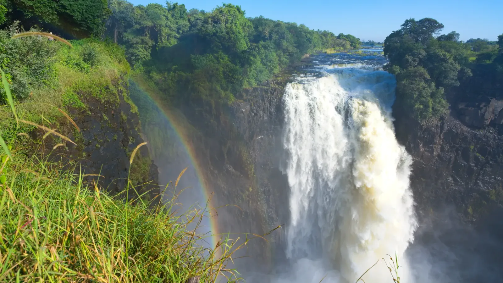 Devil's Cataract by Mr. Wanderer Rushing waterfall with grasses and a rainbow in the foreground