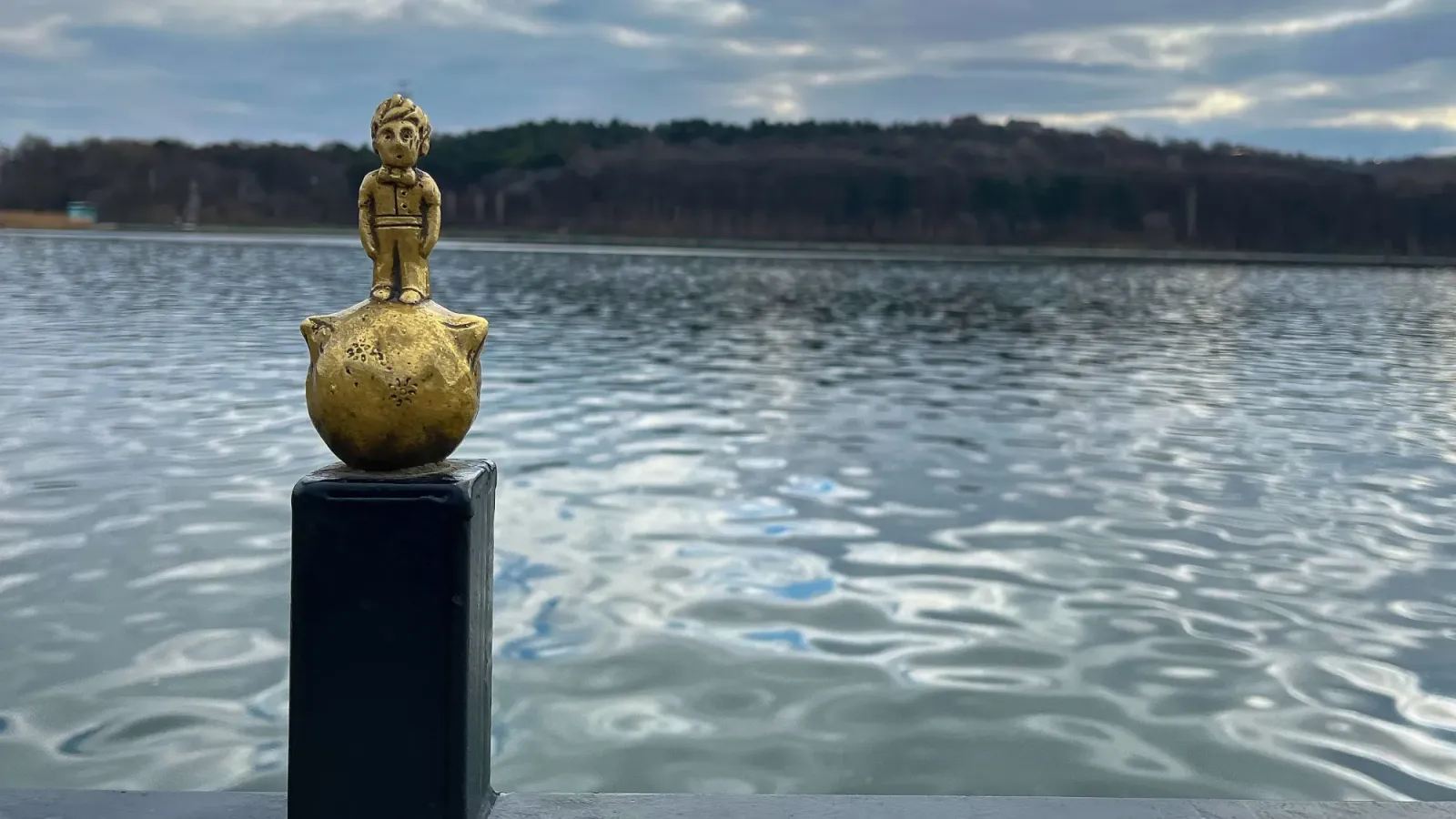 The Little Prince Statuette by Mrs. Wanderer Golden mini-statue of The Little Prince in front of a lake