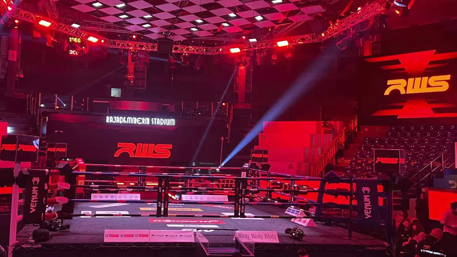Rajadamnern Stadium by Mr. Wanderer Fighting ring inside the stadium lit up with red lights